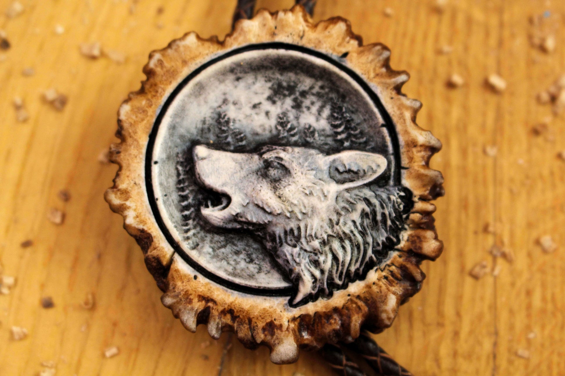 Close up Bolo Tie shot, handmade from Deer Antler with Howling Wolf image