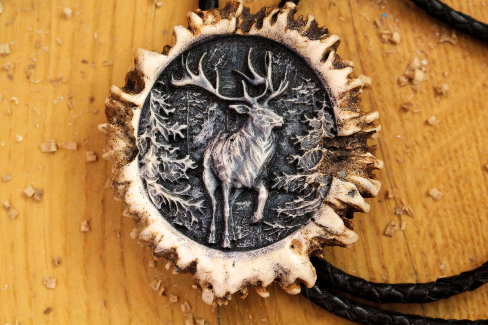 Close up picture of Deer Antler Bolo Tie with exquisite Running Deer image