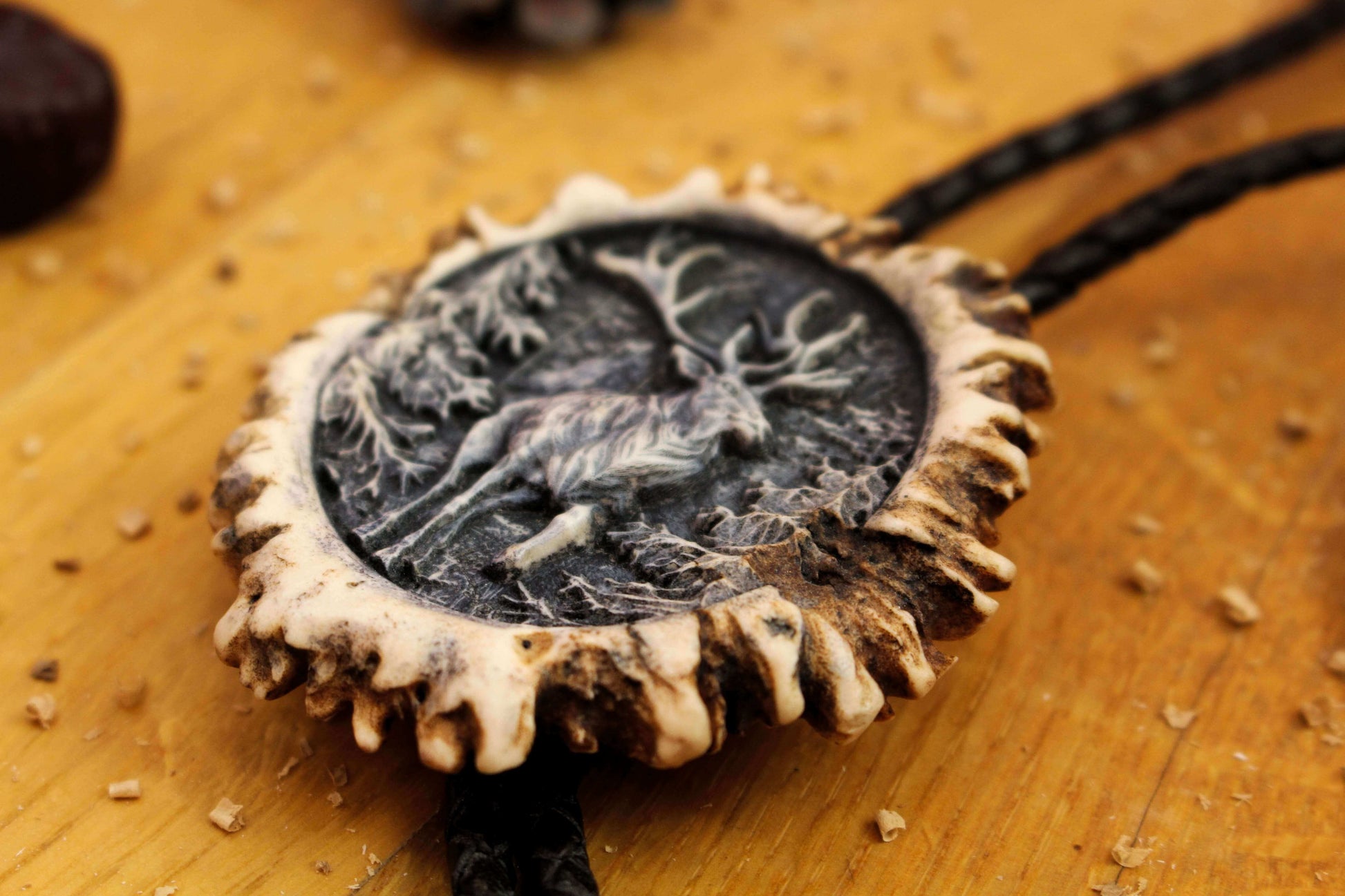 Image from the side of Antler Bolo Tie and a Running Deer Design