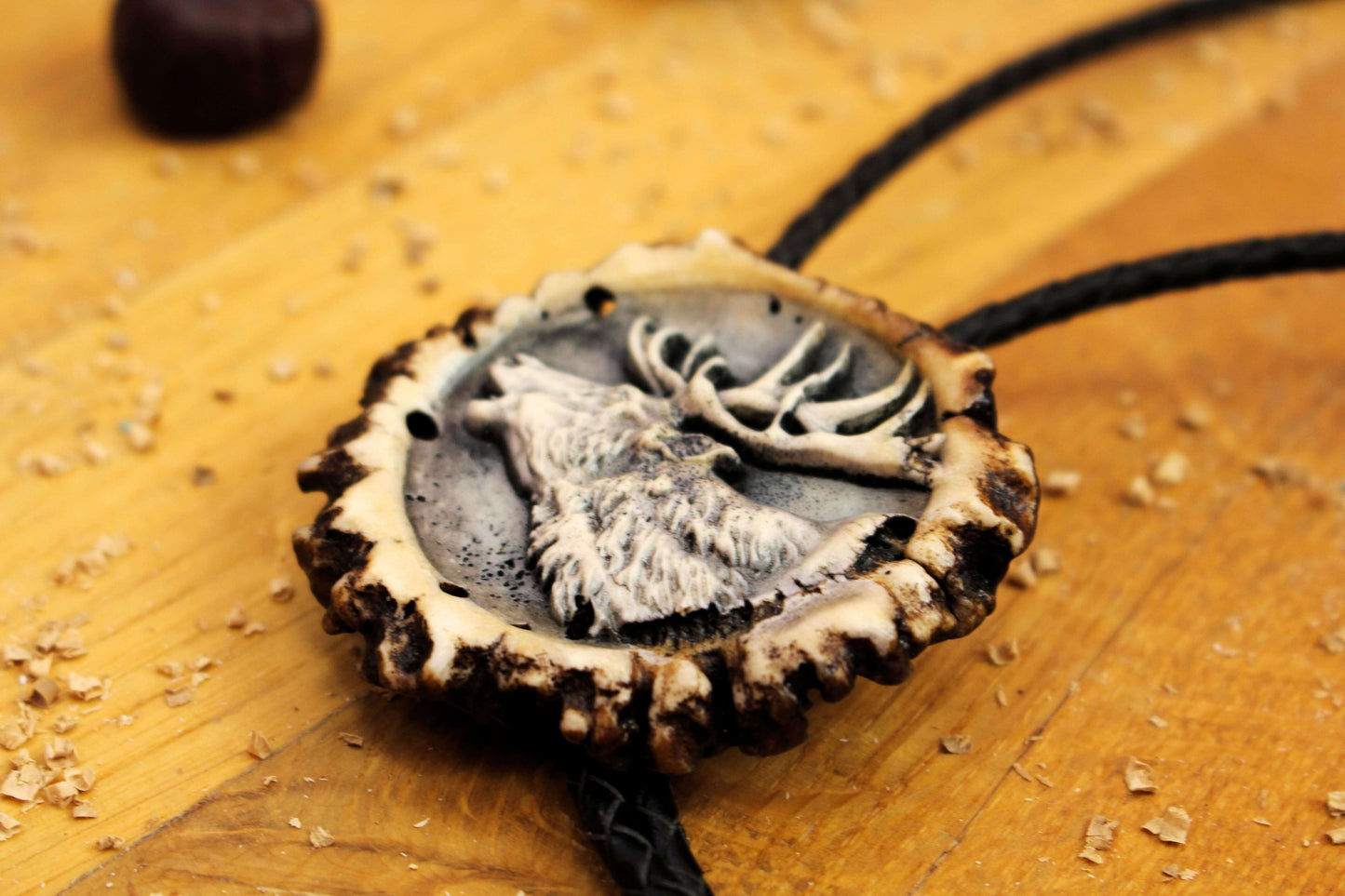 Side picture of Bolo Tie with Deer Portrait design and leather cord