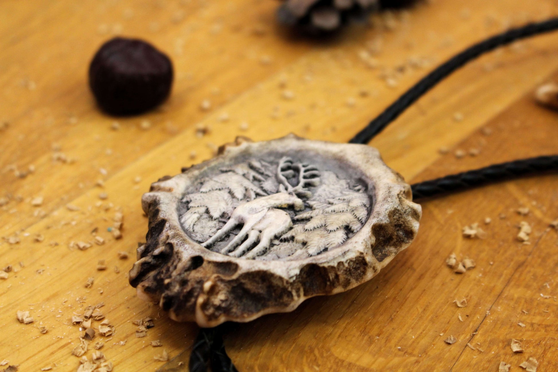 Side picture of Bolo Tie with Standing Deer design and leather cord