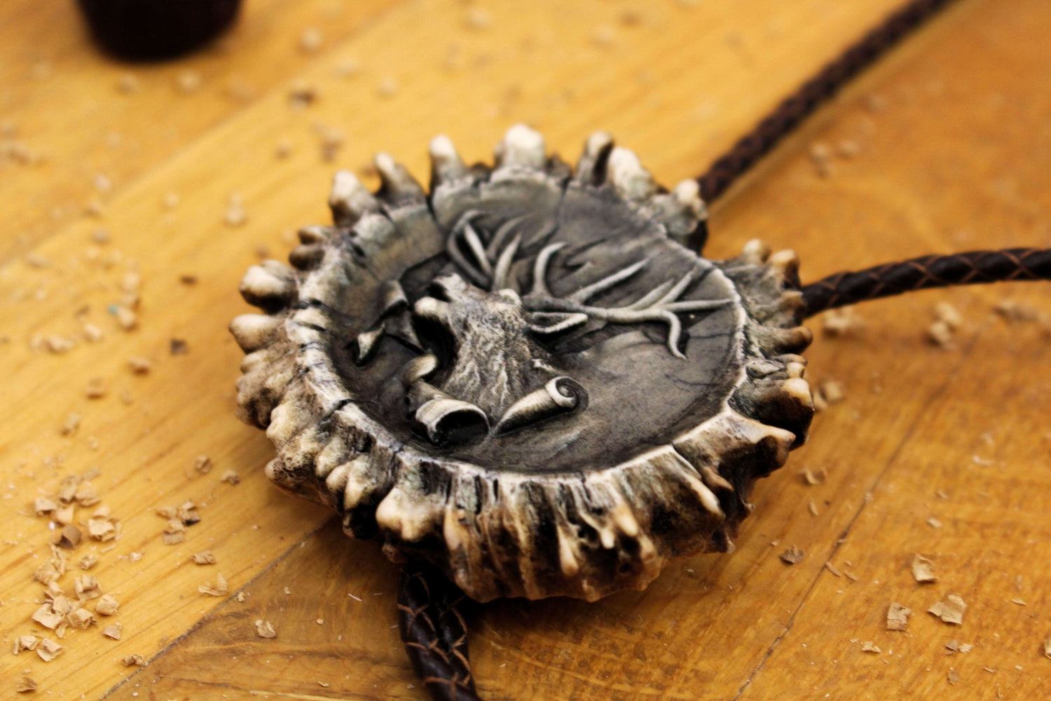 Side Image of handcrafted Antler Bolo Tie and leather cord and unique design