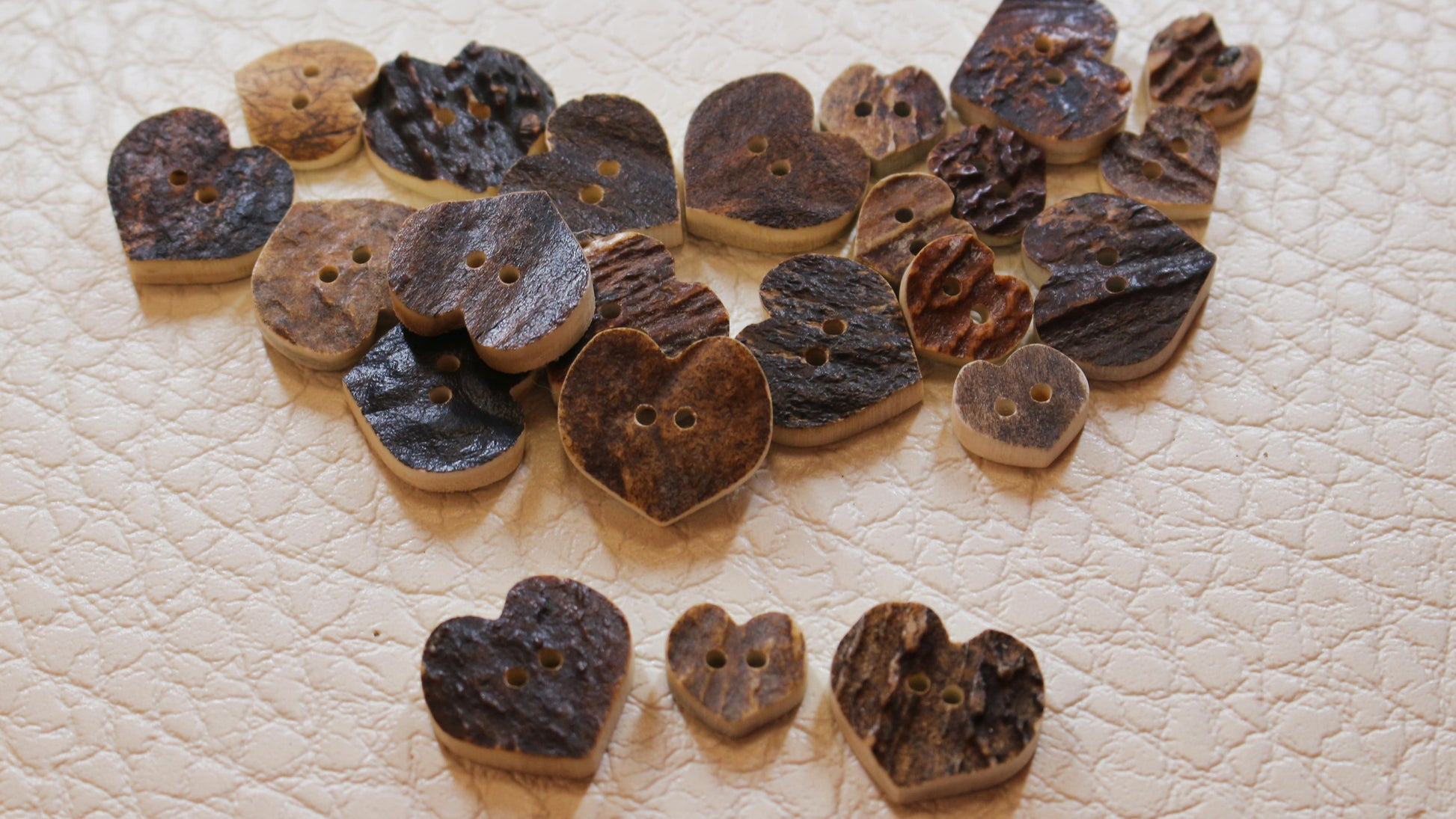 Natural deer antler buttons shaped like heart texture comparison