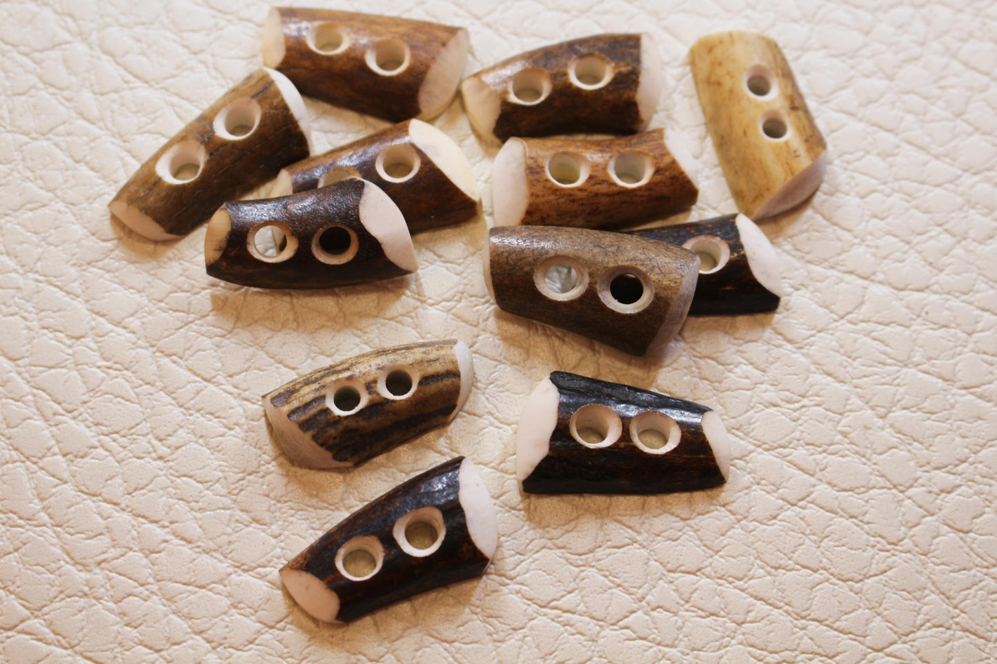Deer antler tips cut in half and made like sewing buttons