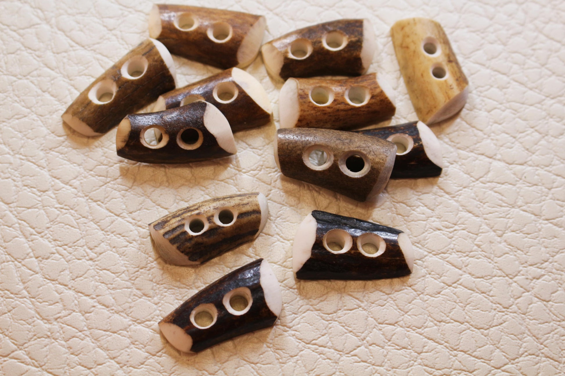 Deer antler tips cut in half and made like sewing buttons