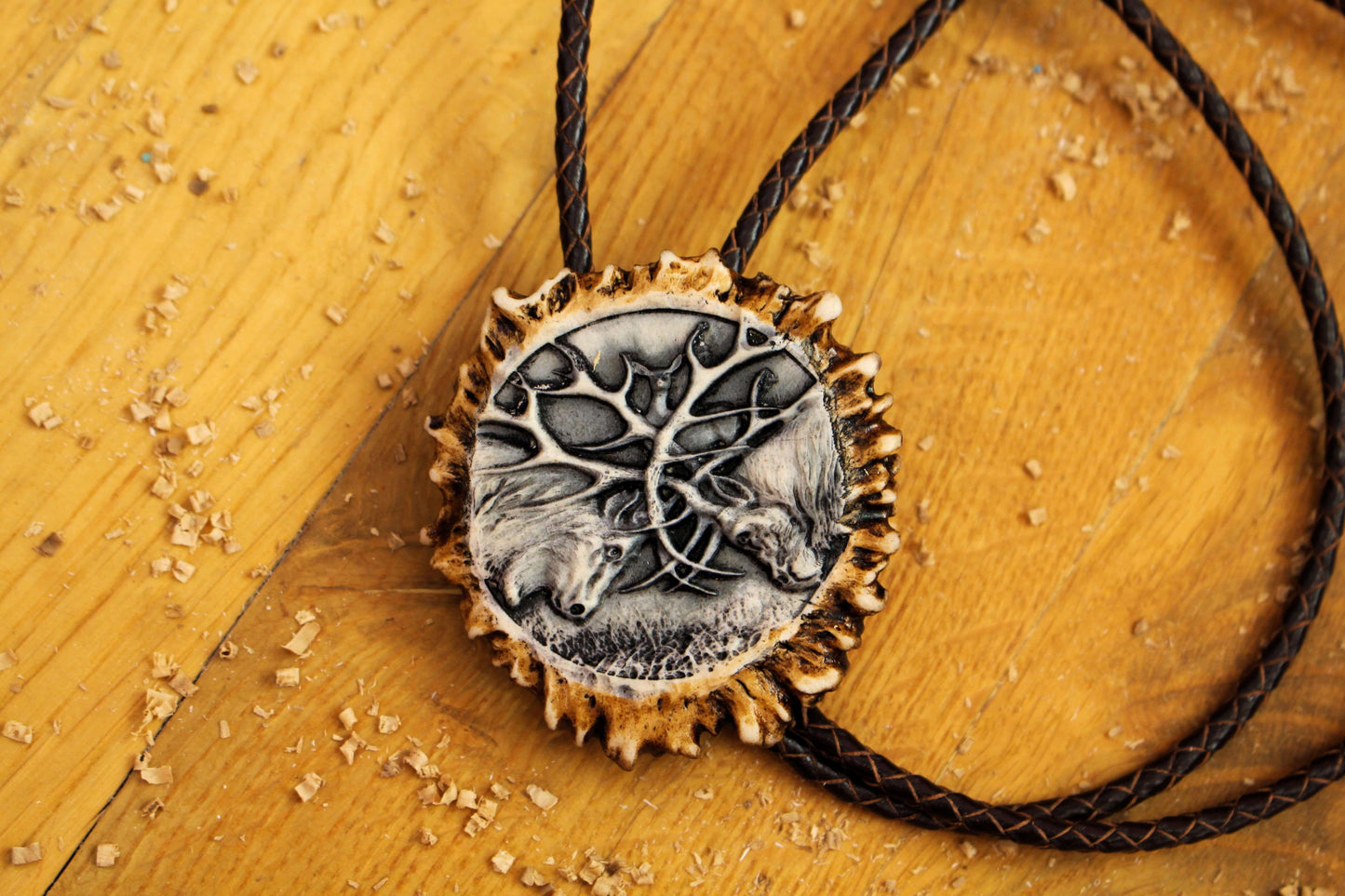 Antler Bolo Tie with close up picture of Fighting Deer Design
